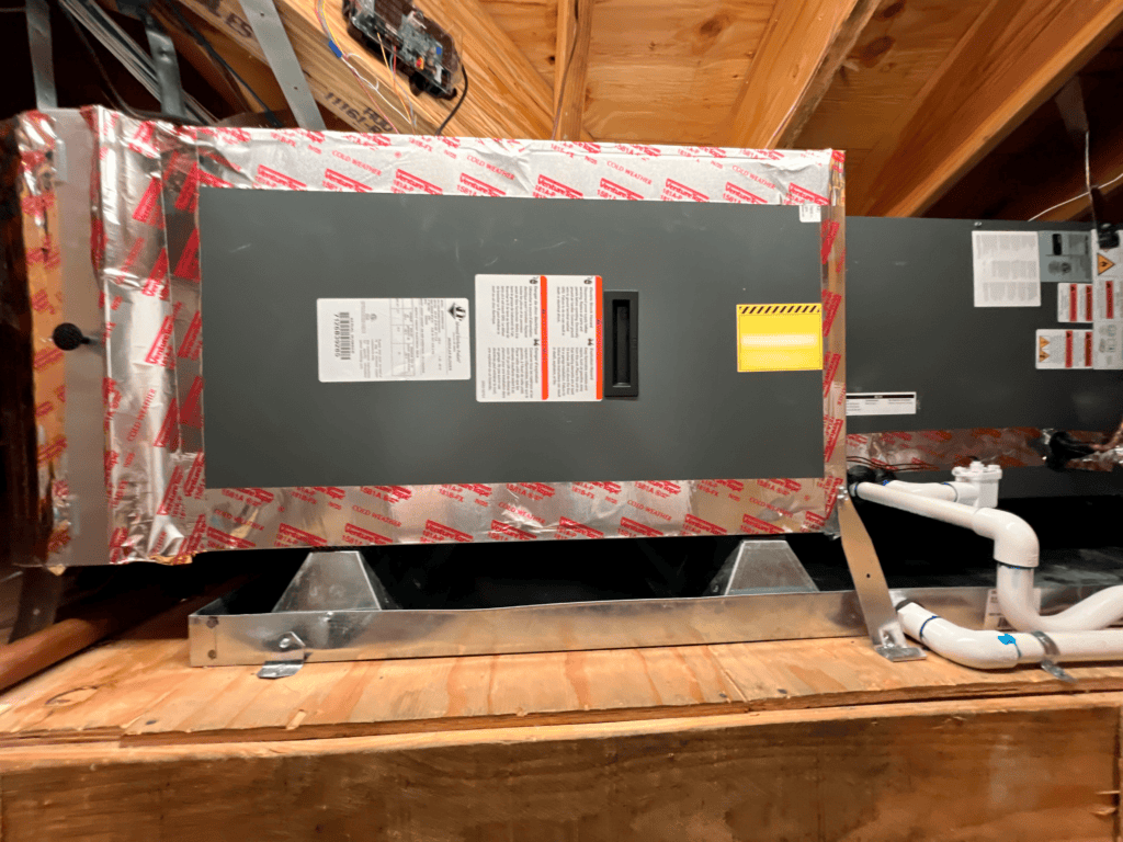HVAC air conditioning unit installed in attic space for home cooling.