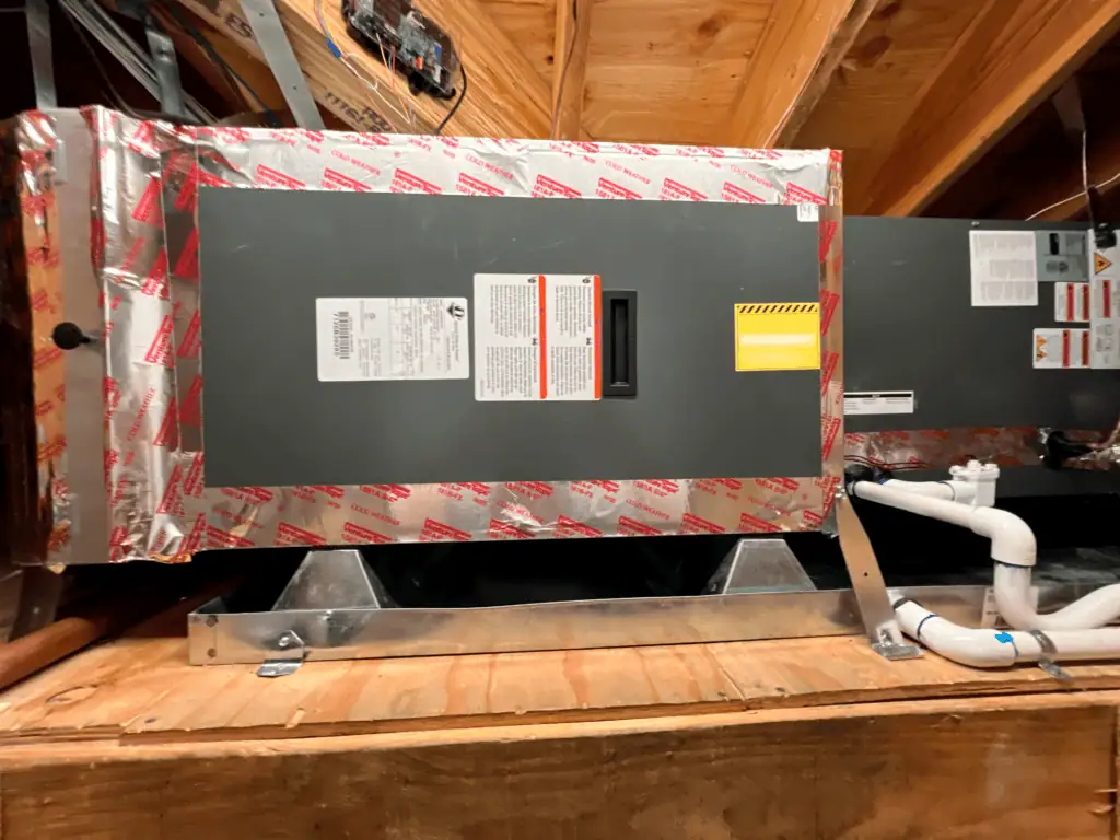 HVAC air conditioning unit installed in attic space for home cooling.